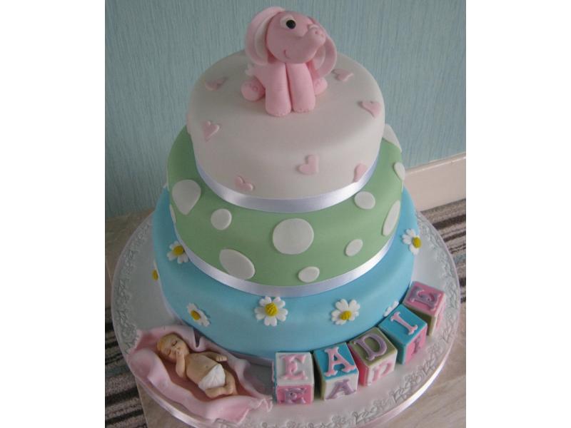 3 Tier of sponges in chocolate and Madeira for Eadie's christening with building blocks, baby and pink elephant from Wigan