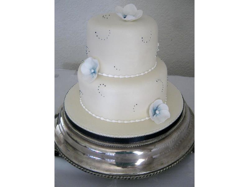 Sarah - Mother of Pearl with white flowers, dusetd in navy Wedding Cake at Ribby Hall