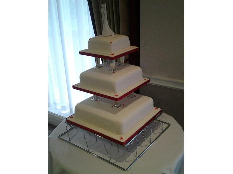 Sharon - 3 tier wedding cake with pillars in white and red for Sharon & James in Rochdale, made from fruit cake and chocolate sponge