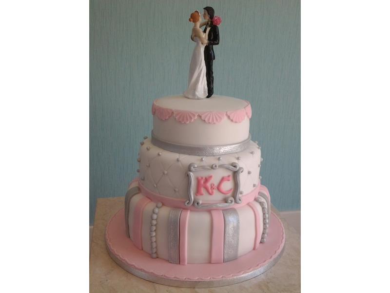 Classical wedding cake - 3 tiers in plain sponge covered in baby pink and silvered decorations