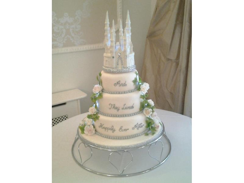 Disney themed wedding cake with castle in 3 tiers of lemon, vanilla and chocolate with orange sponges.