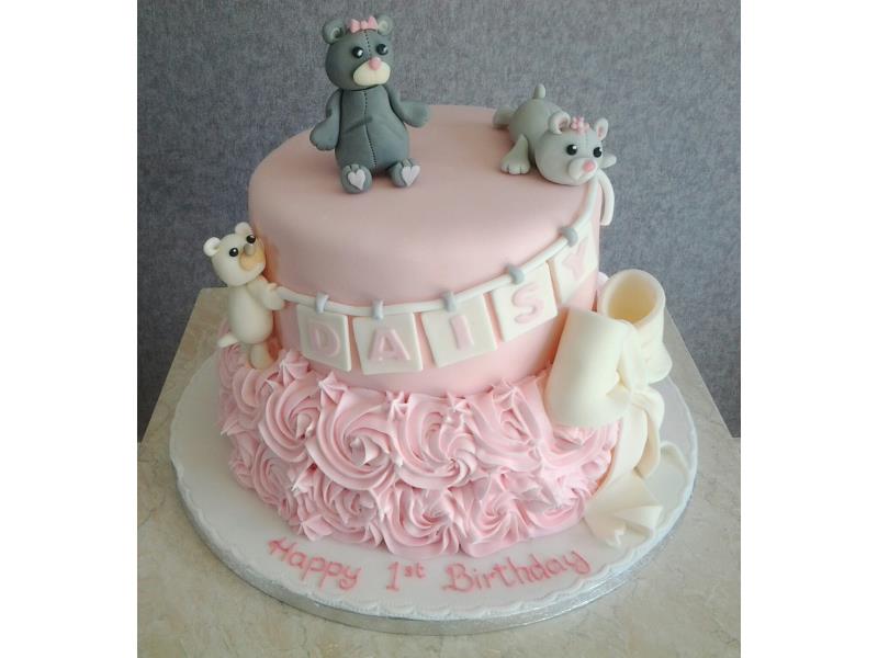 Daisy- 2 Tier pink birthday cake with hand modelled creatures. Sponges are vanilla and chocolate with orange. Thornton-Cleveleys