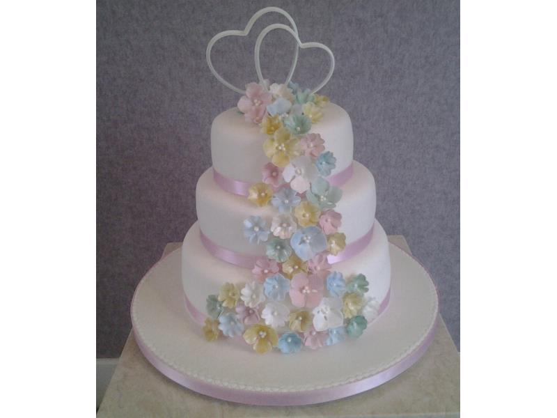 Delicate cascading pastel flowers for 3 tier wedding cake