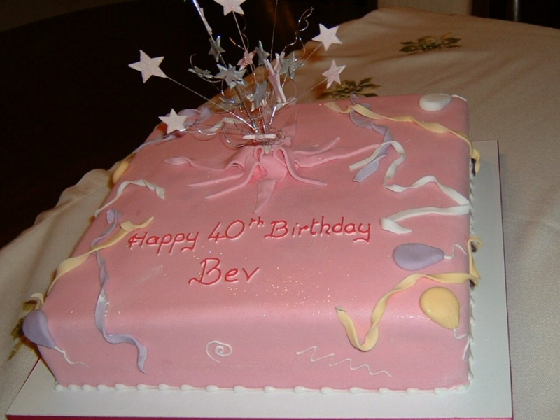 Starburst - Square birthday cake reflecting the personality of the customer with balloons, streamers and glitter